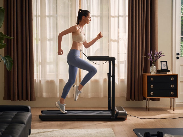 Woman running on a KingSmith WalkingPad R3 Hybrid+ treadmill in a sunlit living room