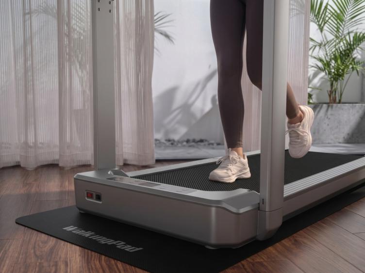 Close-up of a person walking on a KingSmith WalkingPad treadmill at home.